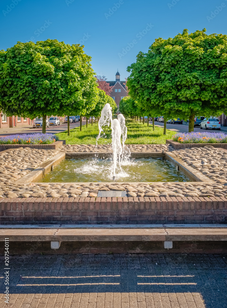In the class neighbourhood of De Riet near the center of Almelo (The Netherlands) there is a fountain. The neighborwood with many small houses was built between the two World Wars for textile workers