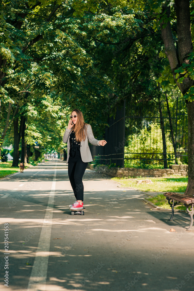 Young Girl On Skateboard Skating Through The Park Young Girl On Skateboard Skating Through The Park