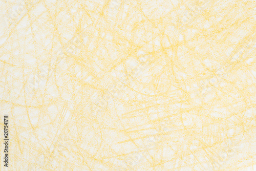 yellow crayon doodles on paper background texture