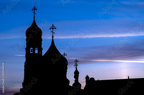 the silhouette of the Church with domes in the early morning at dawn photo