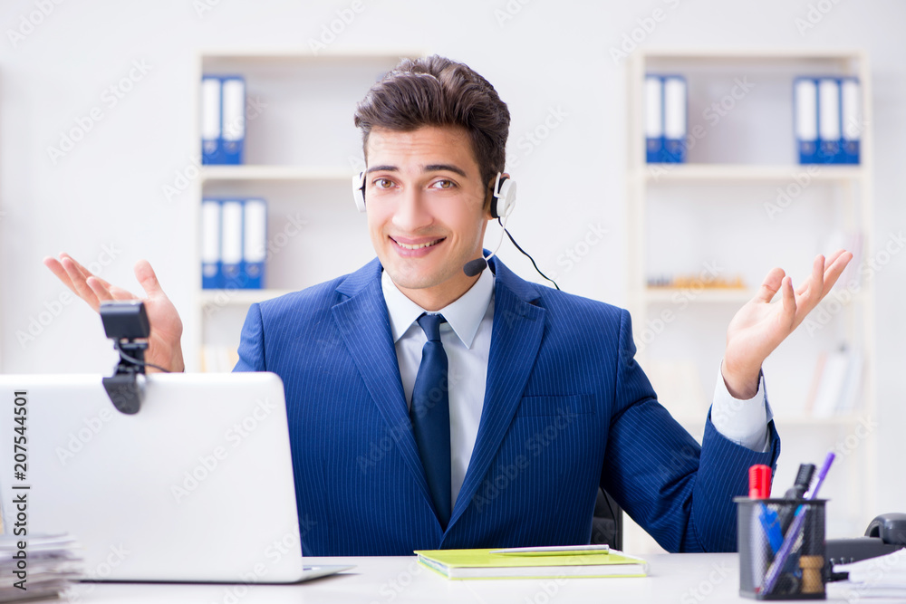Young help desk operator working in office Young help desk operator working in office