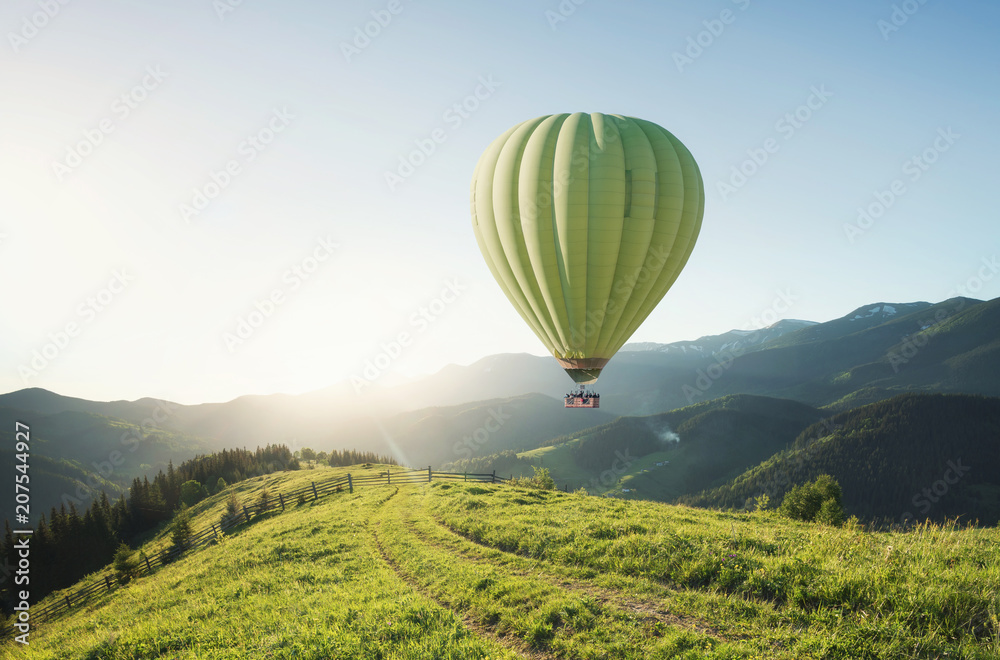 Obraz premium Air ballon above mountains at the summer time. Concept and idea of adventure