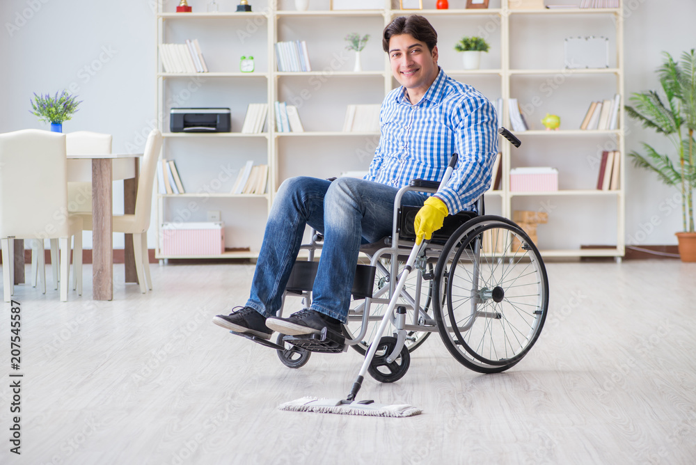 Disabled man on wheelchair cleaning home Disabled man on wheelchair cleaning home