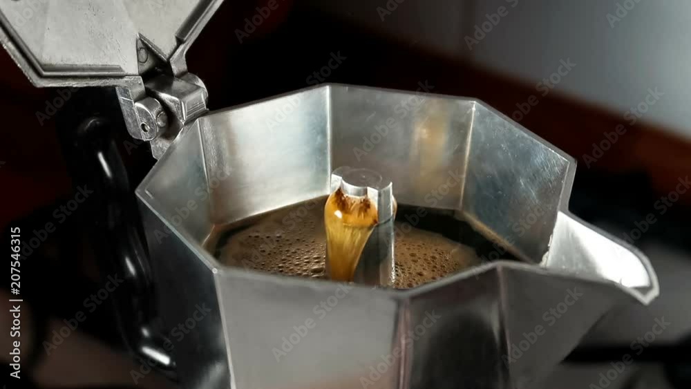Brewing espresso coffee in a stovetop moka express.