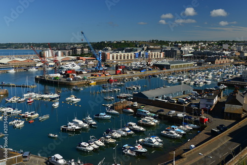 St Helier harbour, Jersey, U.K. June 3rd 2018,  Editorial image of capitals main harbour and freight piers surrounded by the capital and suburbs. © alagz