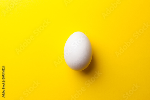 white egg on a yellow background