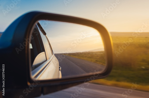 Sunset scene reflection in the mirror of car