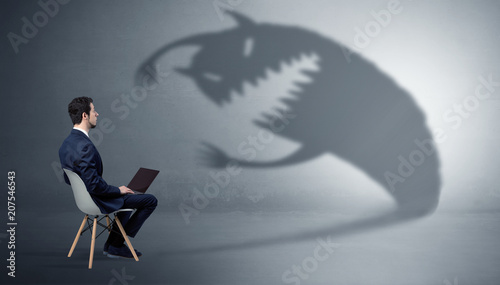 Canvas Print Young businessman staying and  negotiate with a monster shadow