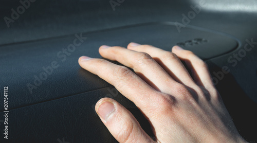 Hand on the airbag in the car salon