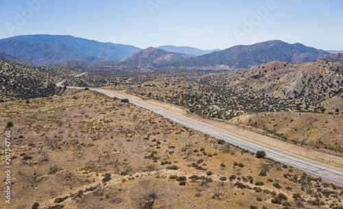 Long Mojave desert road in the midst of the southern California wilderness. photo
