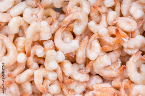 Frozen peeled shrimps. background photo