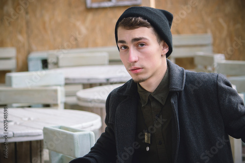 Portrait of young stylish man with bag in the street photo