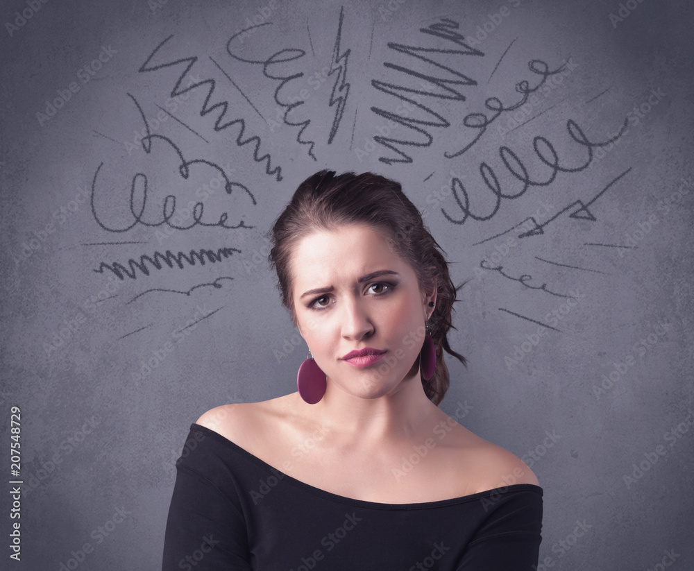 A cute female student making funny face expressions with pressure and problems in her head illustrated by drawn lines, marks and spirals on the urban wall background concept. A cute female student making funny face expressions with pressure and problems in her head illustrated by drawn lines, marks and spirals on the urban wall background concept.