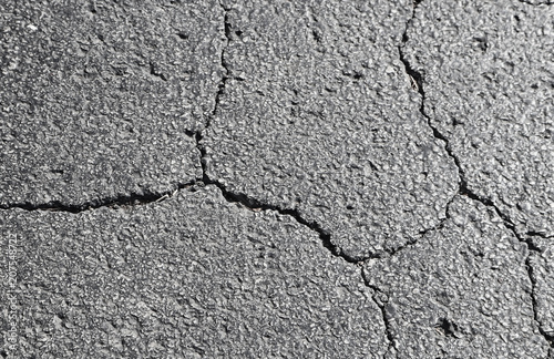 Cracked asphalt - shades of grey - background element