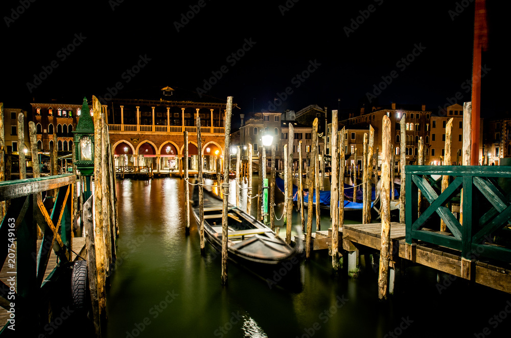 A gondola in Venice is moored up for the night along the Grand Canal