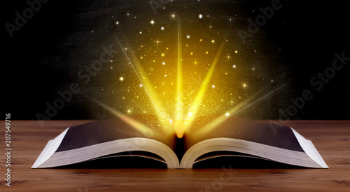 Yellow lights and sparkles coming from an open book  © ra2 studio