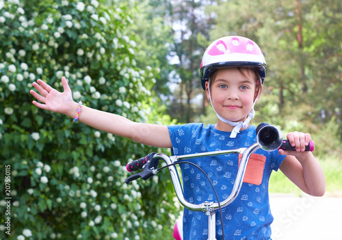 Caucasian child in a protective helmet on a bicycle