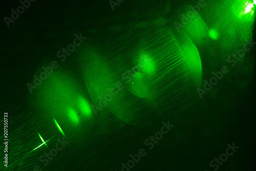 Camera lens flare by laser light create hexagons of objective iris shapes of number depending on number of lens surface and interference effect and moire on digital sensor on dark black background