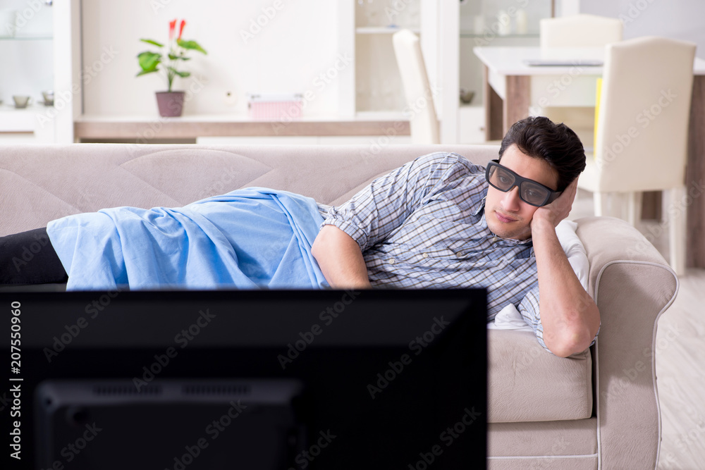 Man watching 3d tv at home
