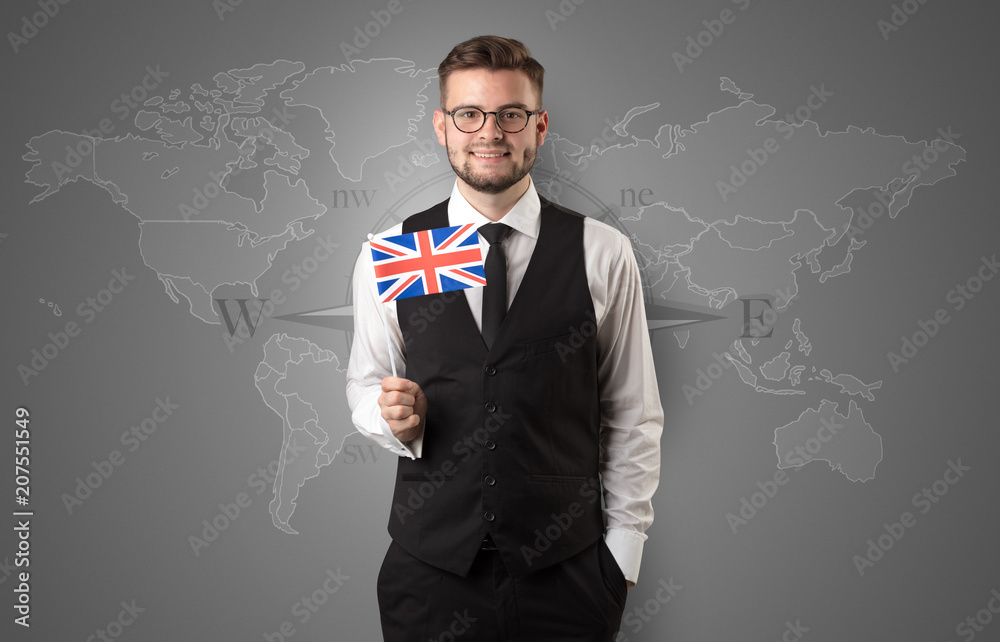 Cheerful businessman standing in front of a map with flag on his hand
Cheerful businessman standing in front of a map with flag on his hand