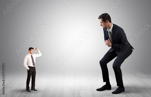 Big debutant young businessman scared of small strong businessman   © ra2 studio