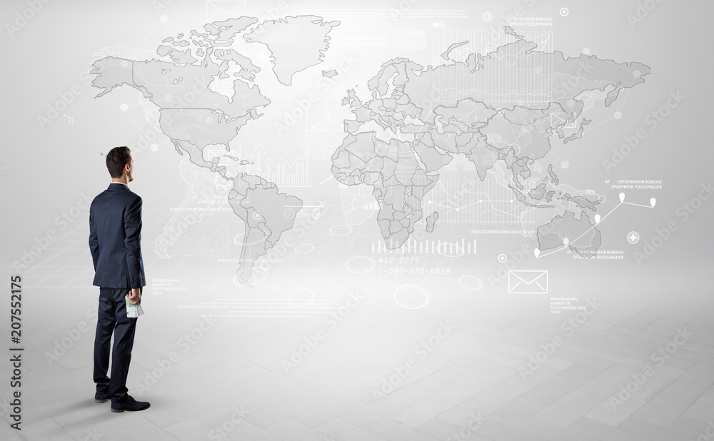 Businessman standing with his back and looking at a worldwide map with objects in his hand
Businessman standing with his back and looking at a worldwide map with objects in his hand