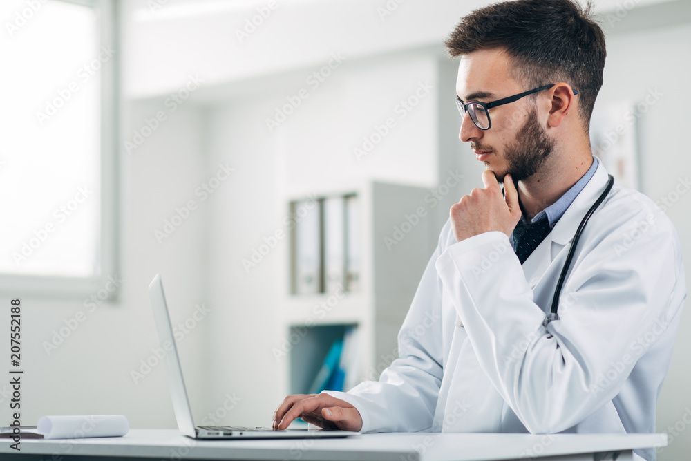 Young doctor working on laptop Young doctor working on laptop