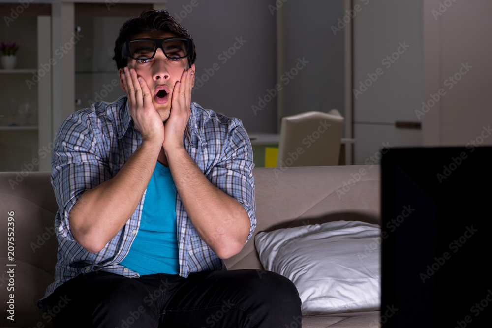 Man watching 3d television late at night Man watching 3d television late at night