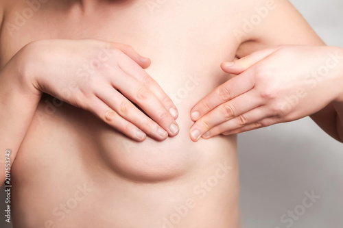 Breast Self-Exam (BSE). woman examining her chest photo
