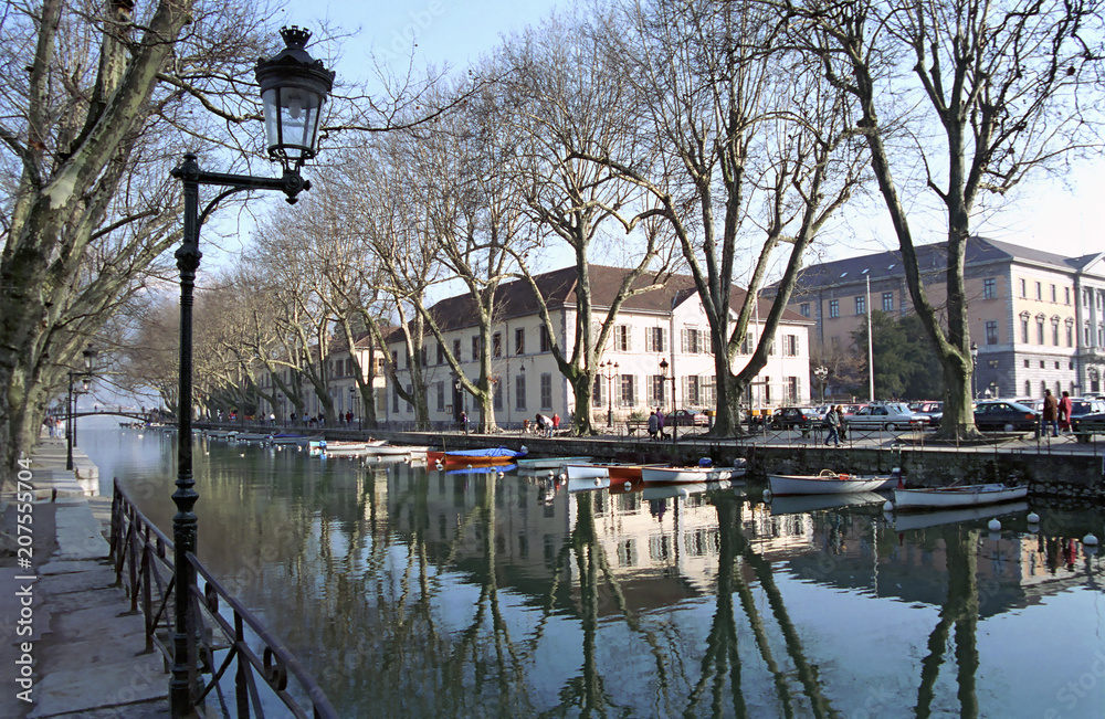 Canal, trees, and boats in Annecy, France.