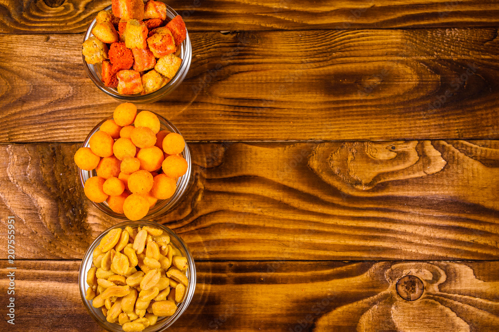 Different snacks for beer on wooden table. Top view Different snacks for beer on wooden table. Top view