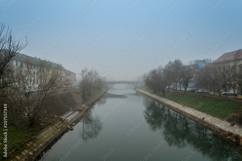 Morning mist over a river. Winter scene.