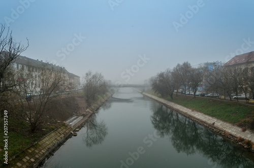Morning mist over a river. Winter scene. © Remus Rigo