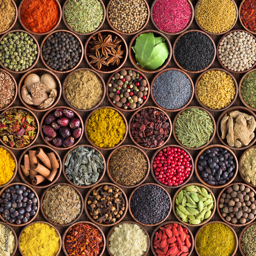 Colorful spices and herbs background. large set of seasonings in cups, top view