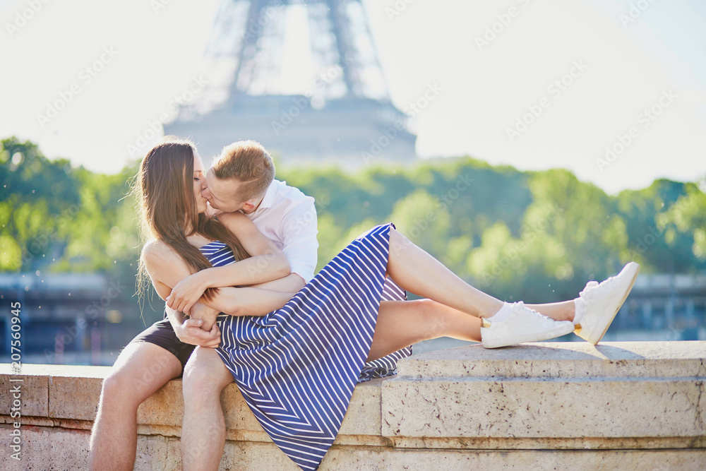 Couple together in Paris kissing near the Eiffel tower