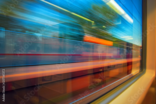 Abstract motion-blurred view from fast moving high speed train. Motion blur view from the window train. Concept traveling by rail