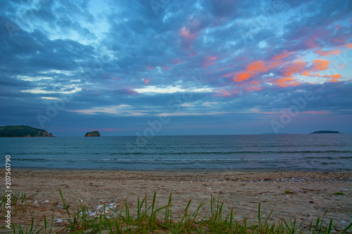 a beach on the sea, sand and waves, seagulls fly over the water.