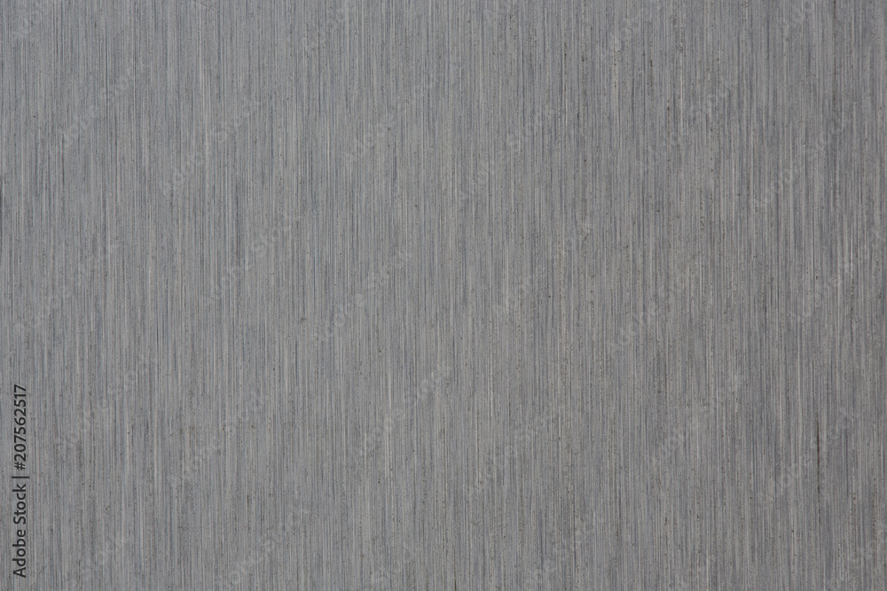 Fototapeta premium Close up industrial background of fractally scratched direct vertical lines to silver metal/stainless steel surface. Creative detail macro photography.