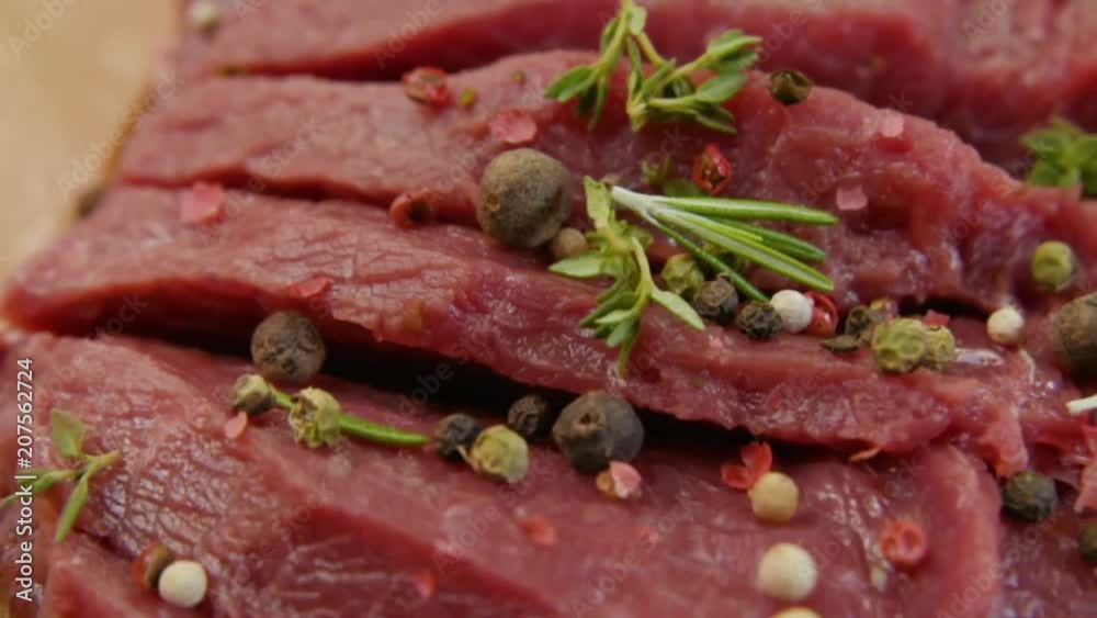 raw beef fillet with pepper and thyme, ready to grill. Rotation raw beef fillet with pepper and thyme, ready to grill. Rotation