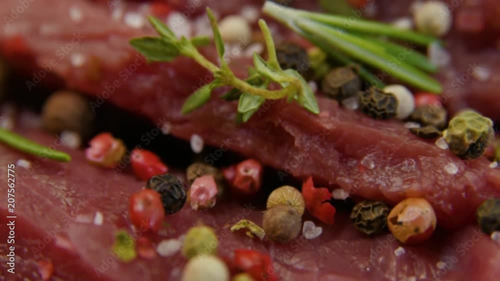 salt close-up sips on a piece of fresh raw beef meat. Marinade meat, preparation for grilling or barbecue. Caucasian kitchen. Rotation. salt close-up sips on a piece of fresh raw beef meat. Marinade meat, preparation for grilling or barbecue. Caucasian kitchen. Rotation.