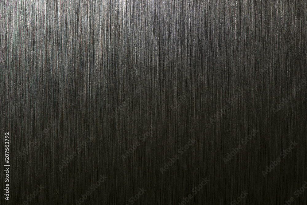 Fototapeta premium Close up industrial background of fractally scratched direct vertical lines to silver metal/stainless steel surface. Creative detail macro photography.