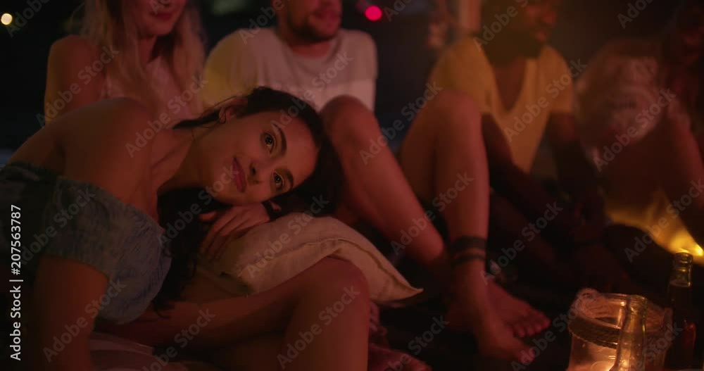 Young woman relaxing at night summer beach party with friends Young woman relaxing at night summer beach party with friends