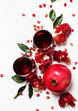 Fresh pomegranate juice in glass on white background, top view