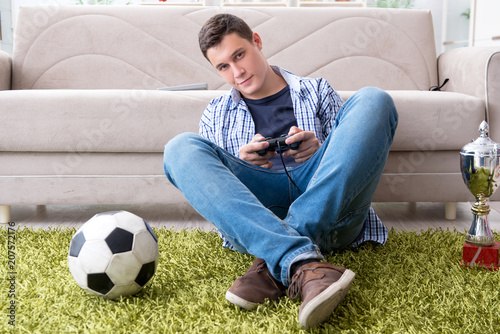 Young man playing computer games at home