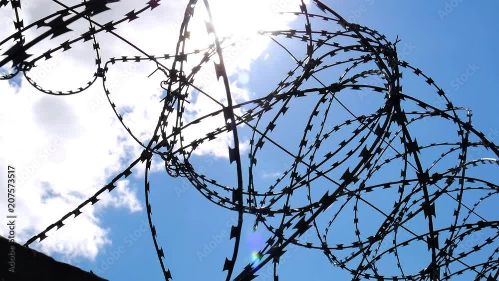Barbed wire fence with Twilight sky to feel Silent and lonely and want freedom. Barbed wire steel wall against the immigration in Europe. Barbed wire fence with Twilight sky to feel Silent and lonely and want freedom. Barbed wire steel wall against the immigration in Europe.
