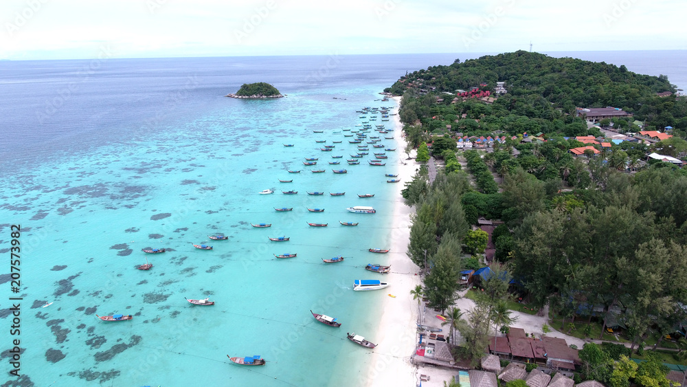 Bird’s eye view of tropical beach and rocky coast with crystal clear turquoise water on LiPE island, sunrise beach,Koh Lipe,Thailand - obrazy, fototapety, plakaty 