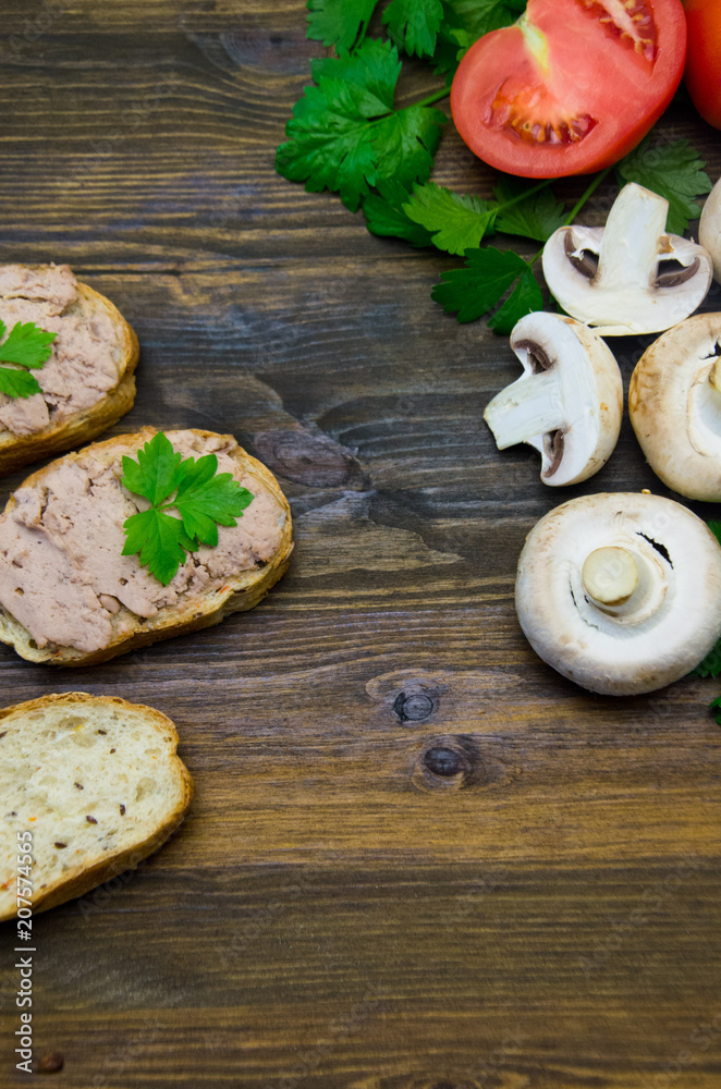 parsley and tomatoes and sandwiches with chicken pate champignons on wooden background 