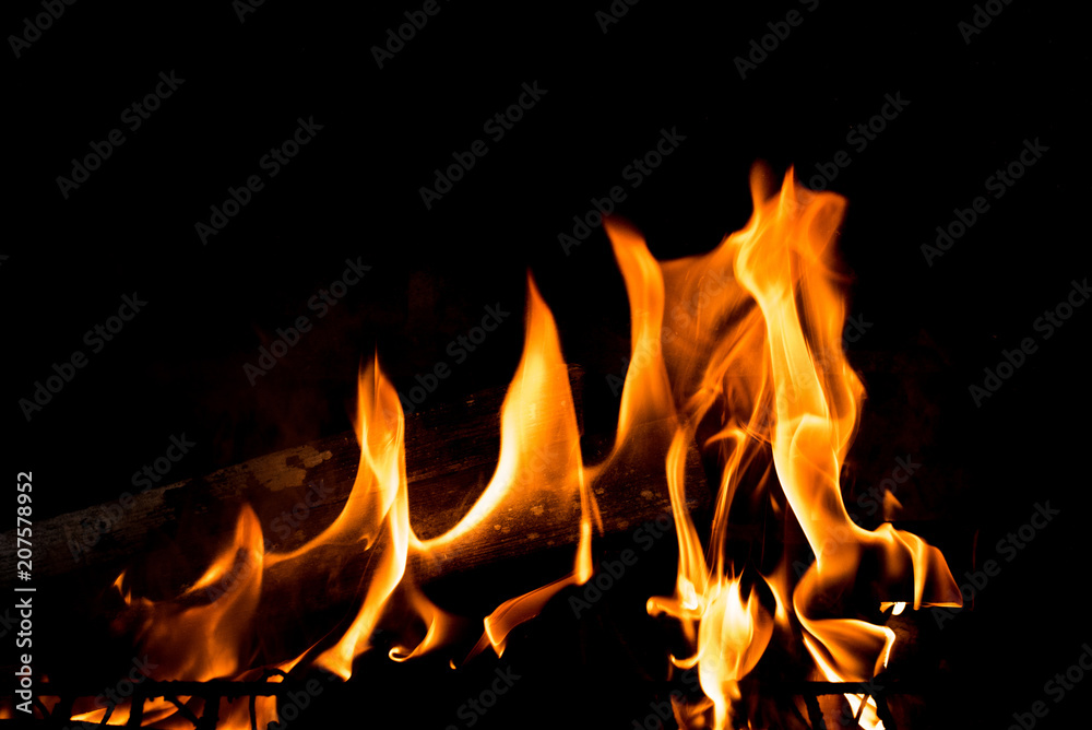 Flames in the fire of a red and yellow barbecue. Flames in the fire of a red and yellow barbecue.