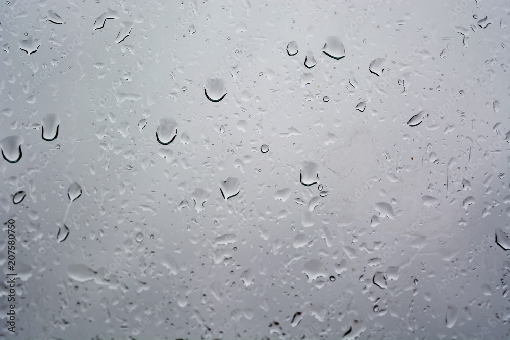 Water rain drop on wet weeping grey surface of window glass. Texture. Background Water rain drop on wet weeping grey surface of window glass. Texture. Background