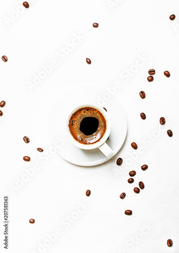 White cup of black coffee espresso with foam, white background, top view